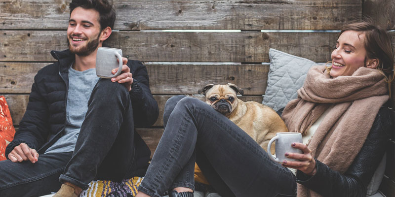 Happy couple in winter enjoying hot chocolate